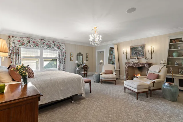 a bedroom with a bed and large windows