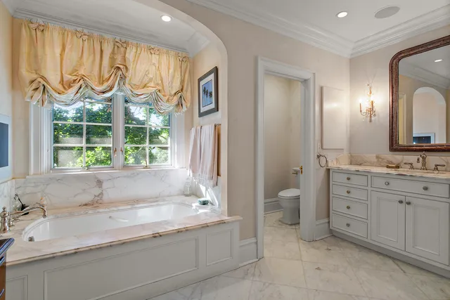 a bathroom with a granite countertop sink and a large mirror