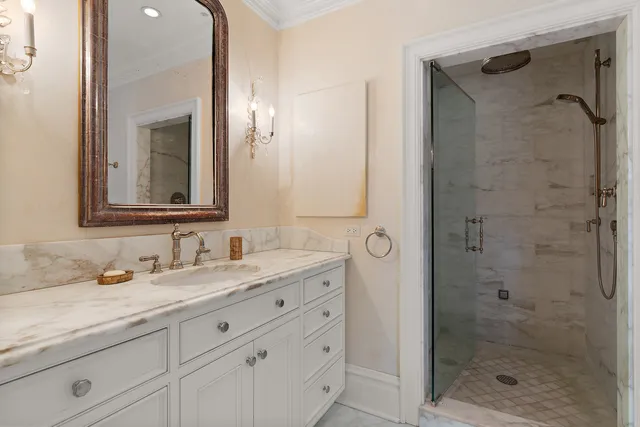a bathroom with a granite countertop sink mirror and shower