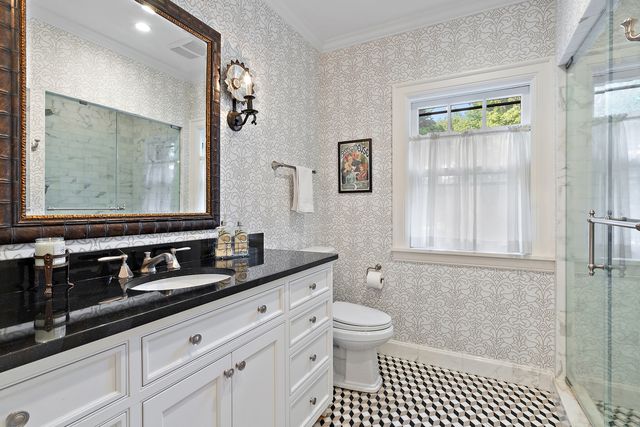 a bathroom with a sink a toilet and a mirror