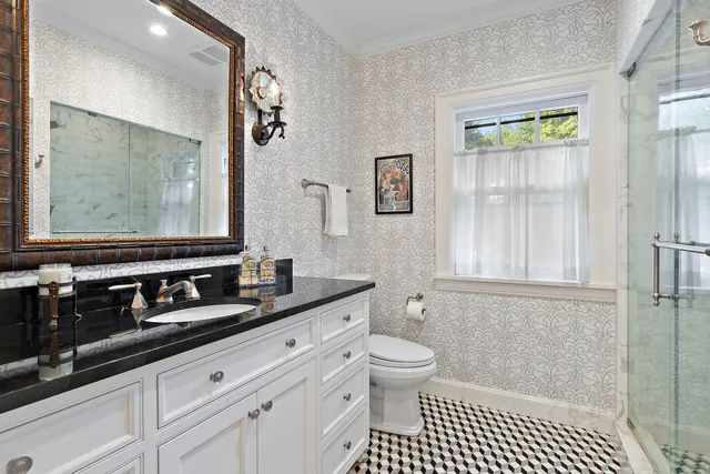 a bathroom with a sink a toilet and a mirror