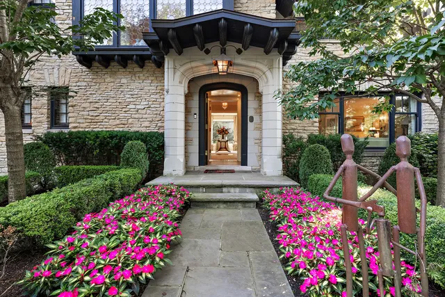 a front view of a house with lots of flowers