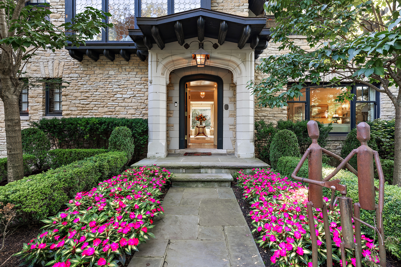640 Hill Road Winnetka, IL 60093 - Photo 3 of 52 a front view of a house with lots of flowers
