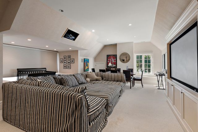 a kitchen with stainless steel appliances kitchen island granite countertop a refrigerator and cabinets
