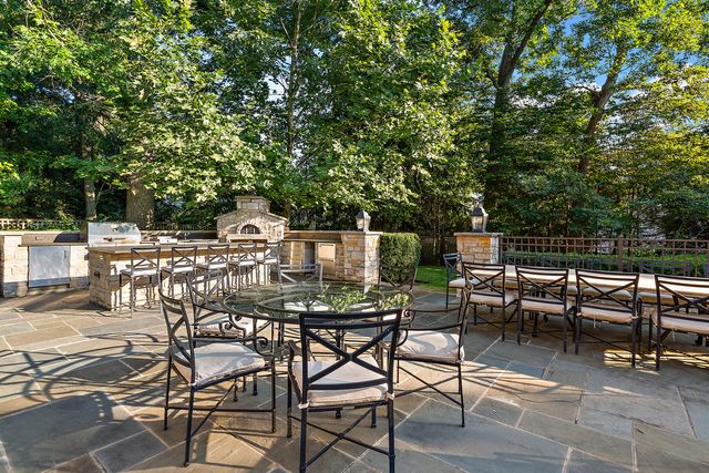 a view of a patio with table and chairs with wooden floor and fence