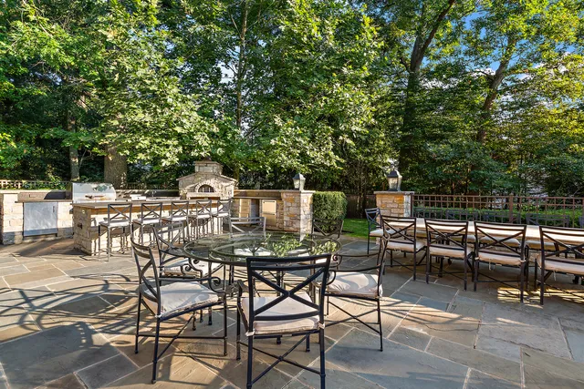 a view of a patio with table and chairs with wooden floor and fence