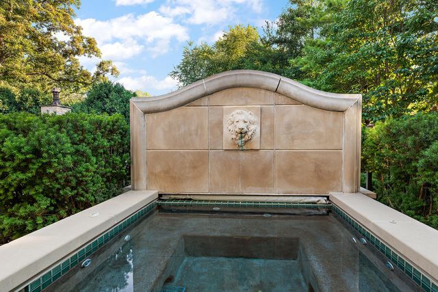 an aerial view of a house with a garden and lake view