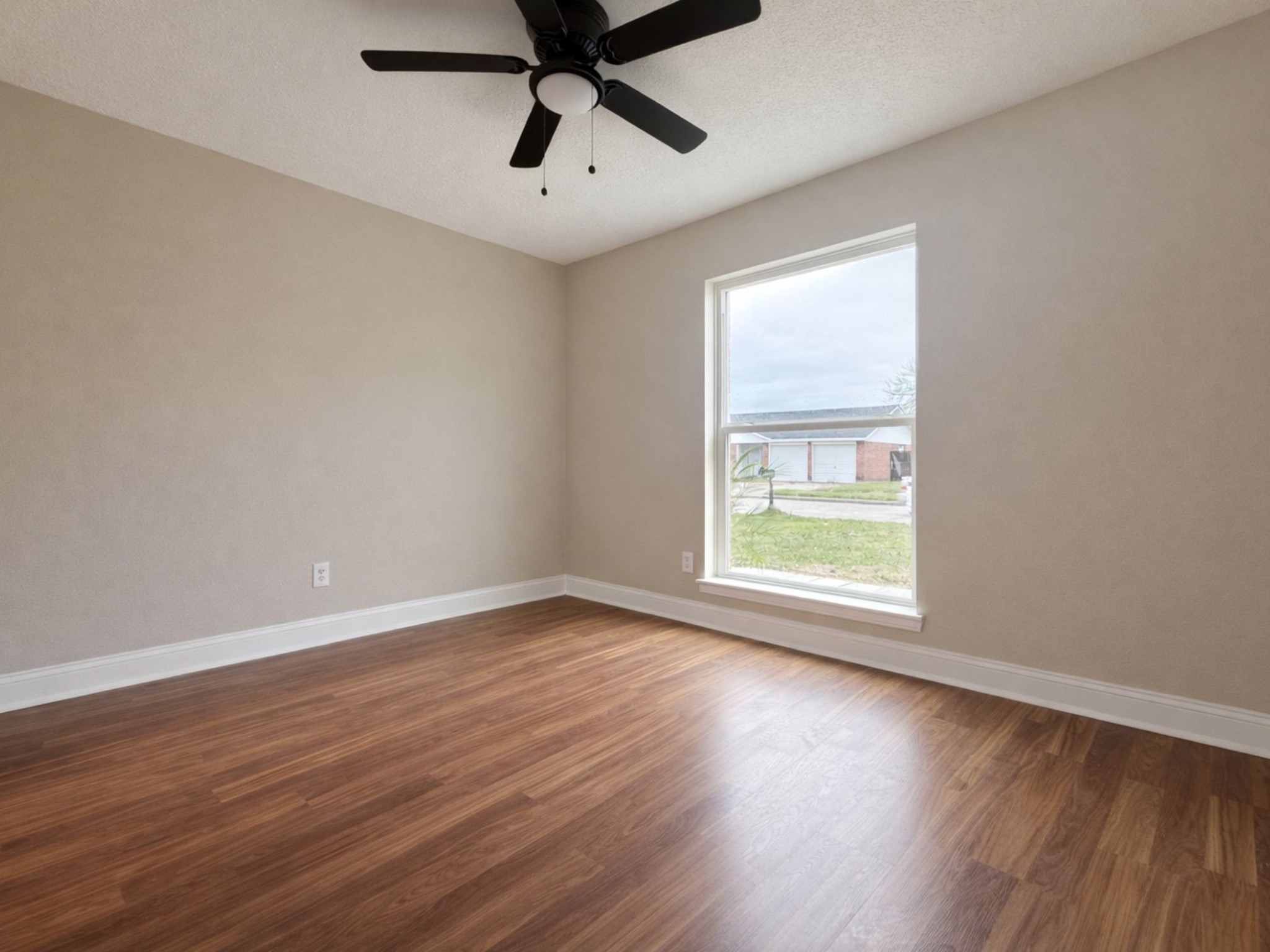 1318 Epsilon Street Pasadena, TX 77504 - Photo 2 of 15 an empty room with wooden floor and windows