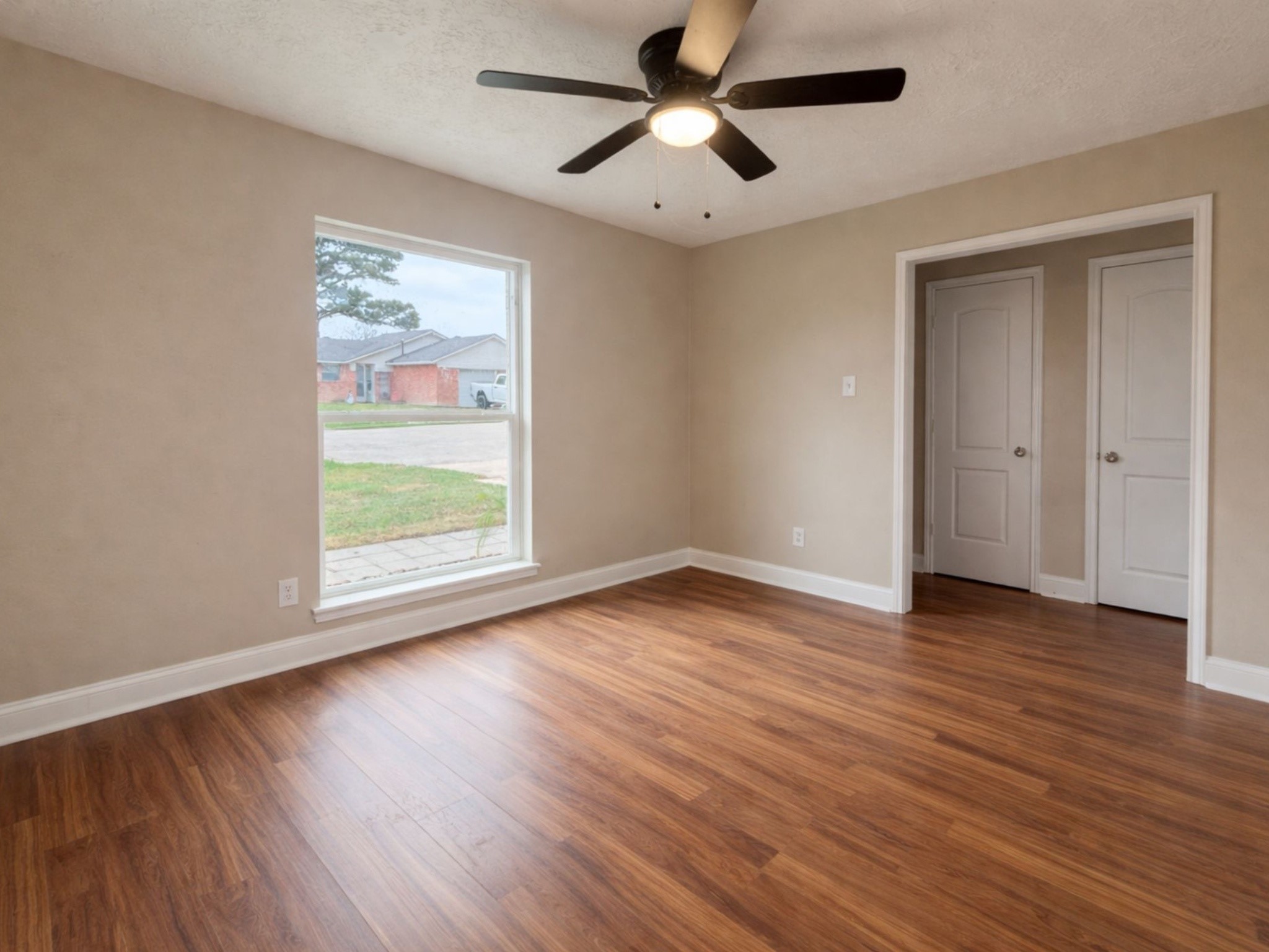 1318 Epsilon Street Pasadena, TX 77504 - Photo 3 of 15 a view of empty room with wooden floor and fan