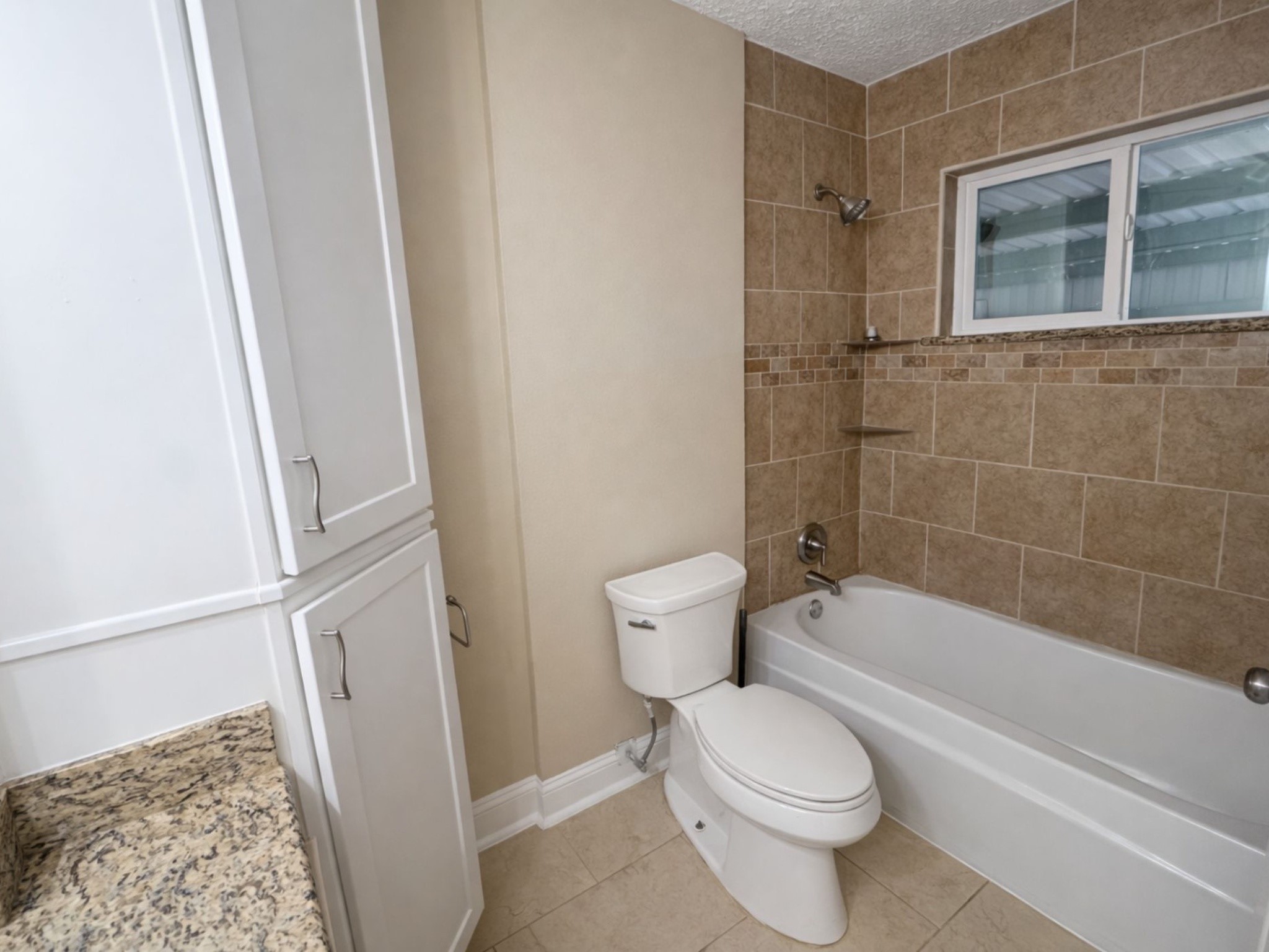 1318 Epsilon Street Pasadena, TX 77504 - Photo 7 of 15 a bathroom with a toilet and a shower