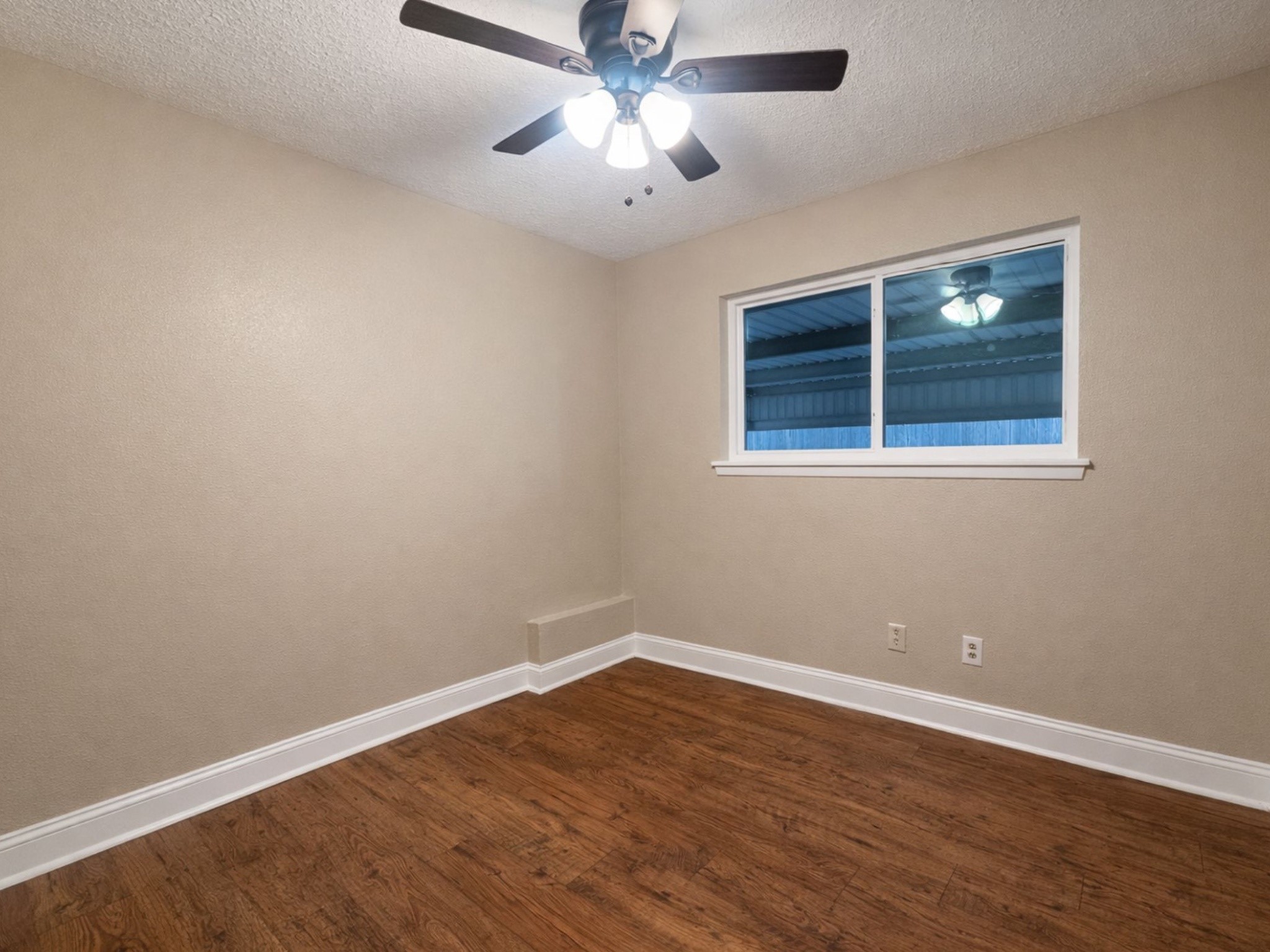 1318 Epsilon Street Pasadena, TX 77504 - Photo 9 of 15 a view of an empty room with wooden floor and a window