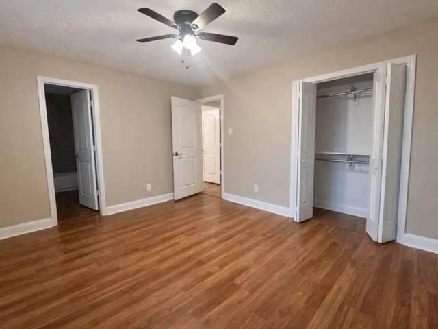 a view of empty room with wooden floor