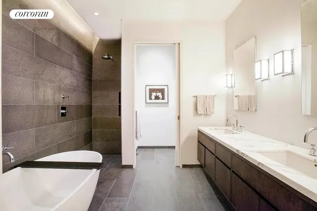 a bathroom with a granite countertop sink a toilet a mirror and shower
