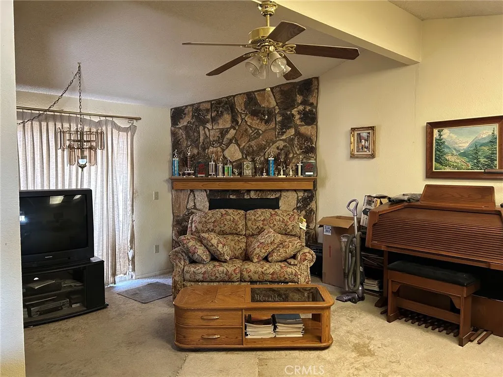 27250 Murrieta Road, Unit 347 Menifee, CA 92586 - Photo 12 of 38 a living room with furniture a flat screen tv and a walk in closet