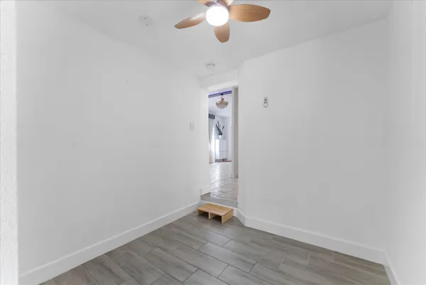 a view of an empty room with wooden floor