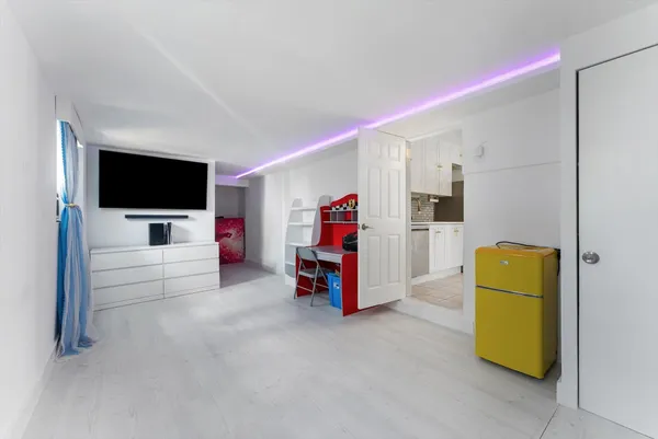 a bedroom with a bed and a flat screen television