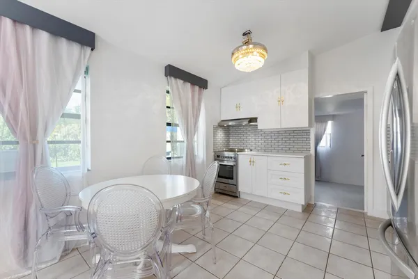 a kitchen with stainless steel appliances kitchen island granite countertop a refrigerator and a stove top oven