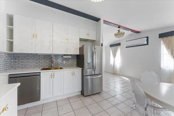 a kitchen with granite countertop a refrigerator and a sink