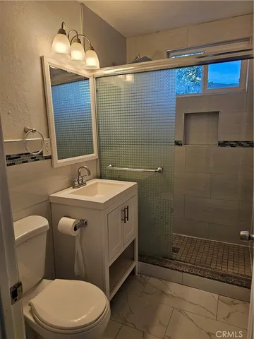 a bathroom with a sink a toilet and mirror