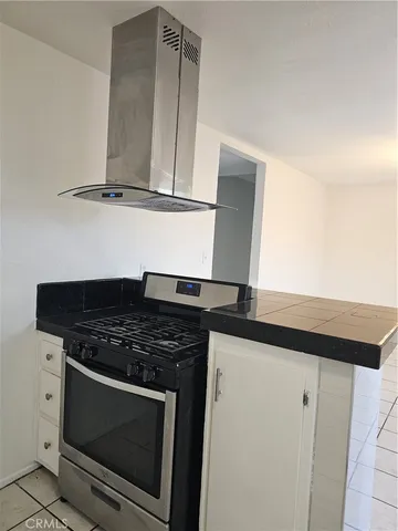 a kitchen with stainless steel appliances granite countertop a stove and a microwave