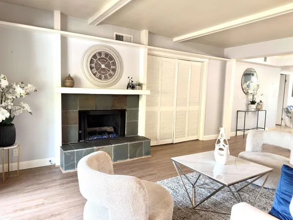 a living room with furniture and a fireplace