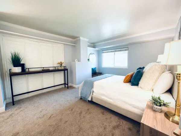 a bedroom with a bed and window