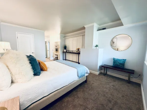 a bedroom with a bed and a chandelier
