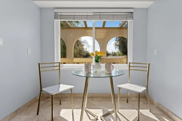 a view of a room with a table and chairs