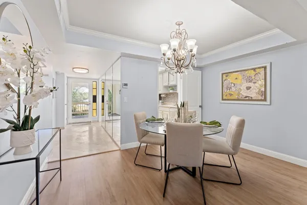 a view of a dining room with furniture wooden floor and chandelier
