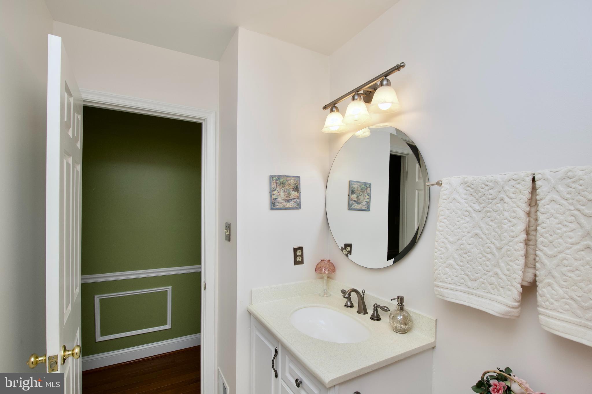 6690 Old Blacksmith Drive Burke, VA 22015 - Photo 19 of 46 a bathroom with a sink and a mirror