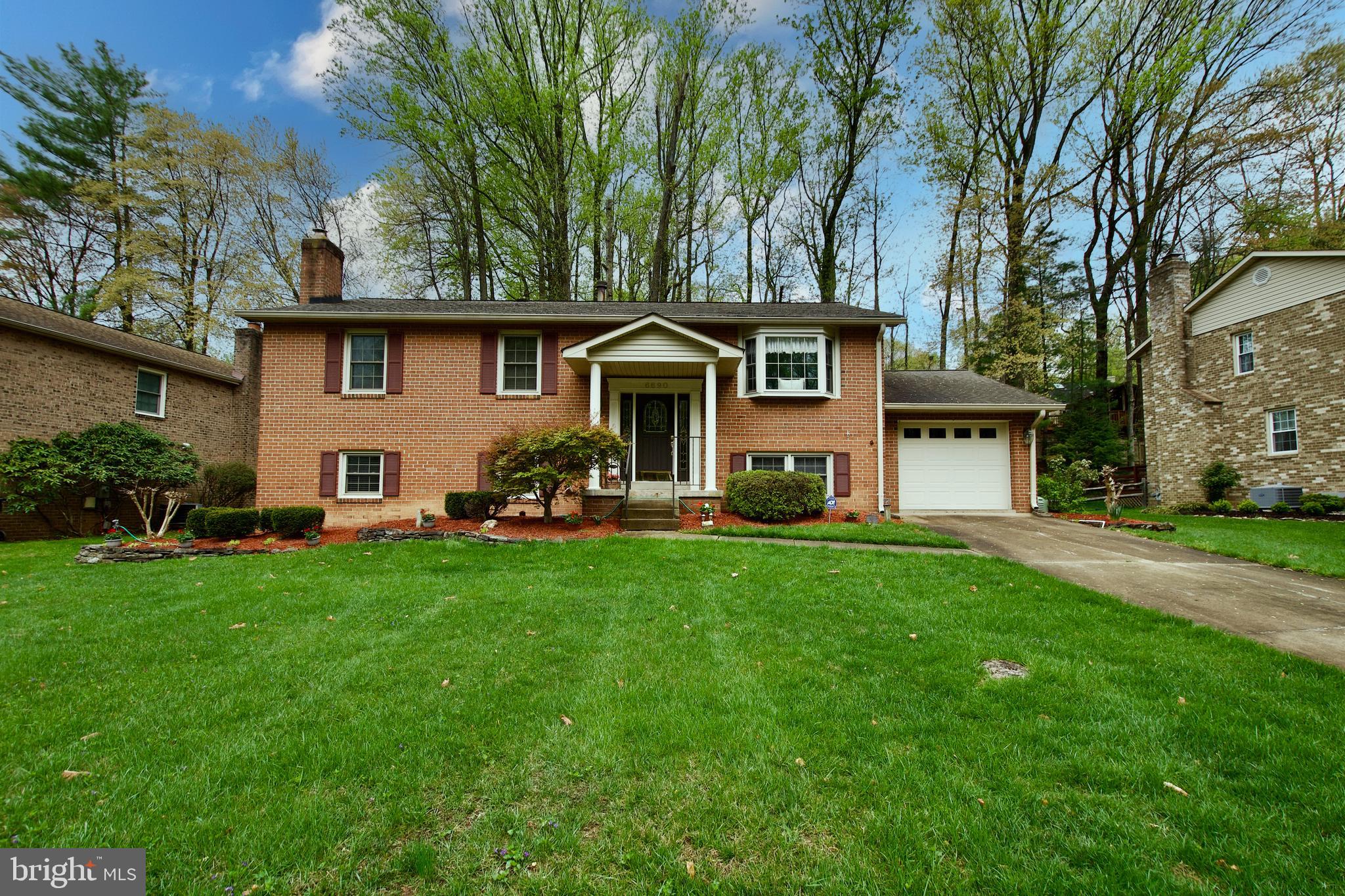 6690 Old Blacksmith Drive Burke, VA 22015 - Photo 2 of 46 a front view of house with yard and green space
