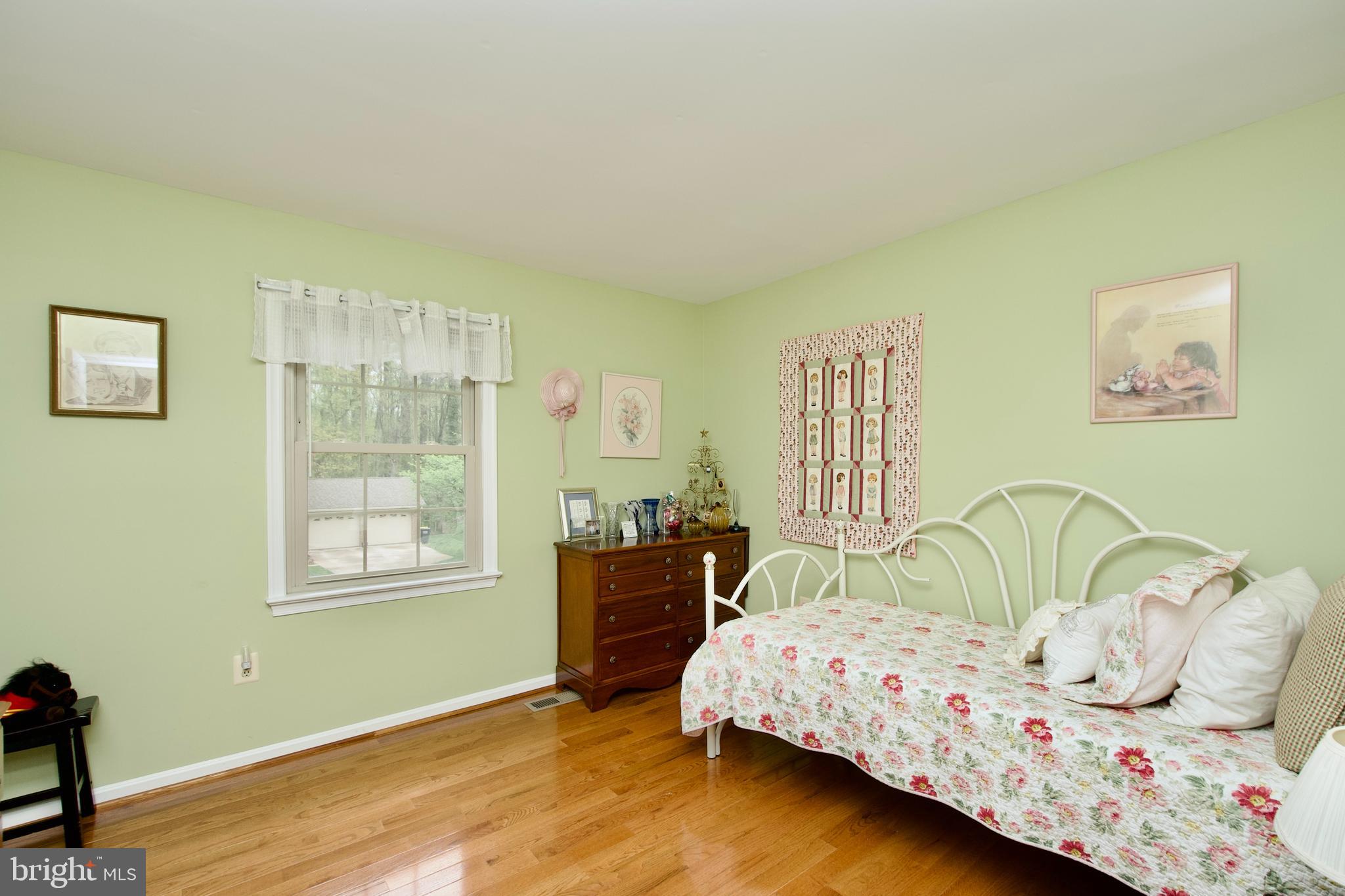 6690 Old Blacksmith Drive Burke, VA 22015 - Photo 22 of 46 a bedroom with a bed and wooden floor