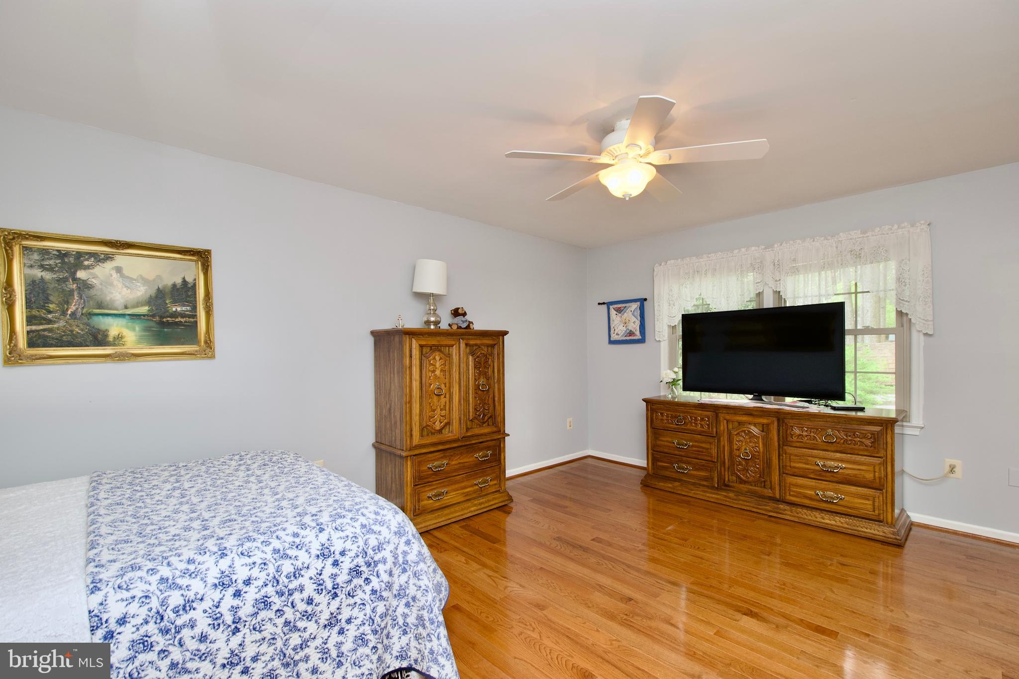 6690 Old Blacksmith Drive Burke, VA 22015 - Photo 24 of 46 a bedroom with furniture and a flat screen tv
