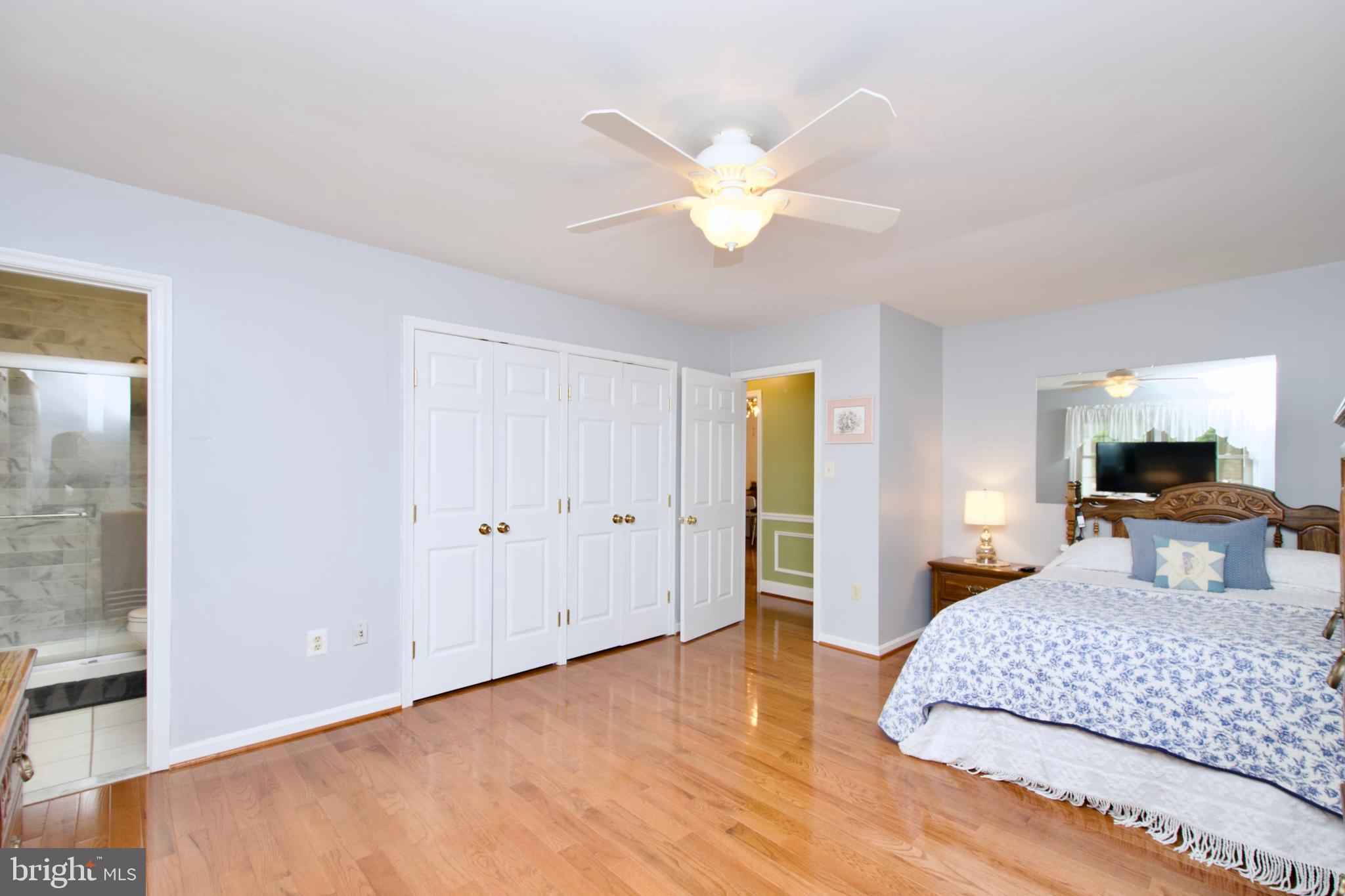 6690 Old Blacksmith Drive Burke, VA 22015 - Photo 26 of 46 a bedroom with a bed and a chandelier