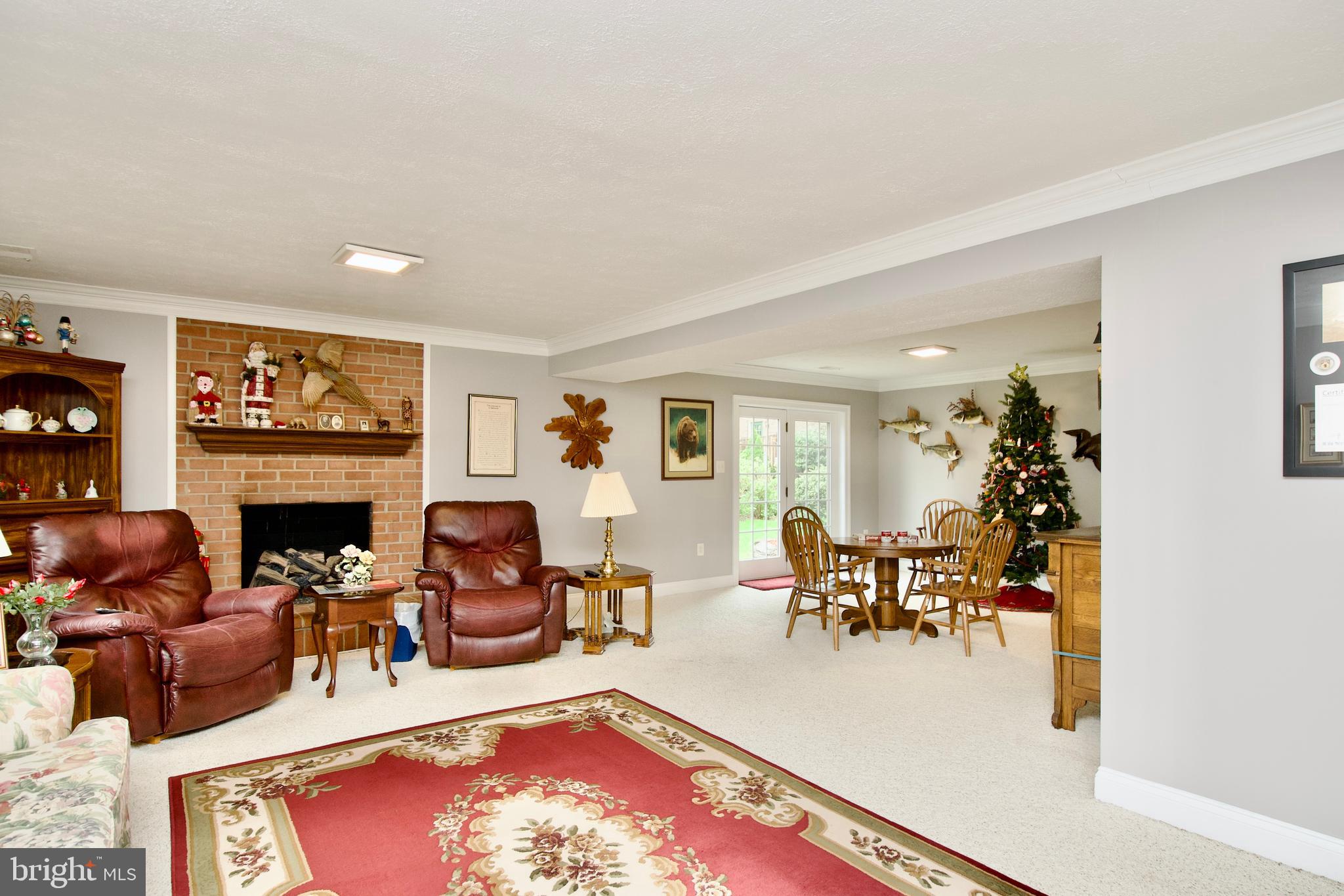 6690 Old Blacksmith Drive Burke, VA 22015 - Photo 32 of 46 a living room with furniture a fireplace and a window