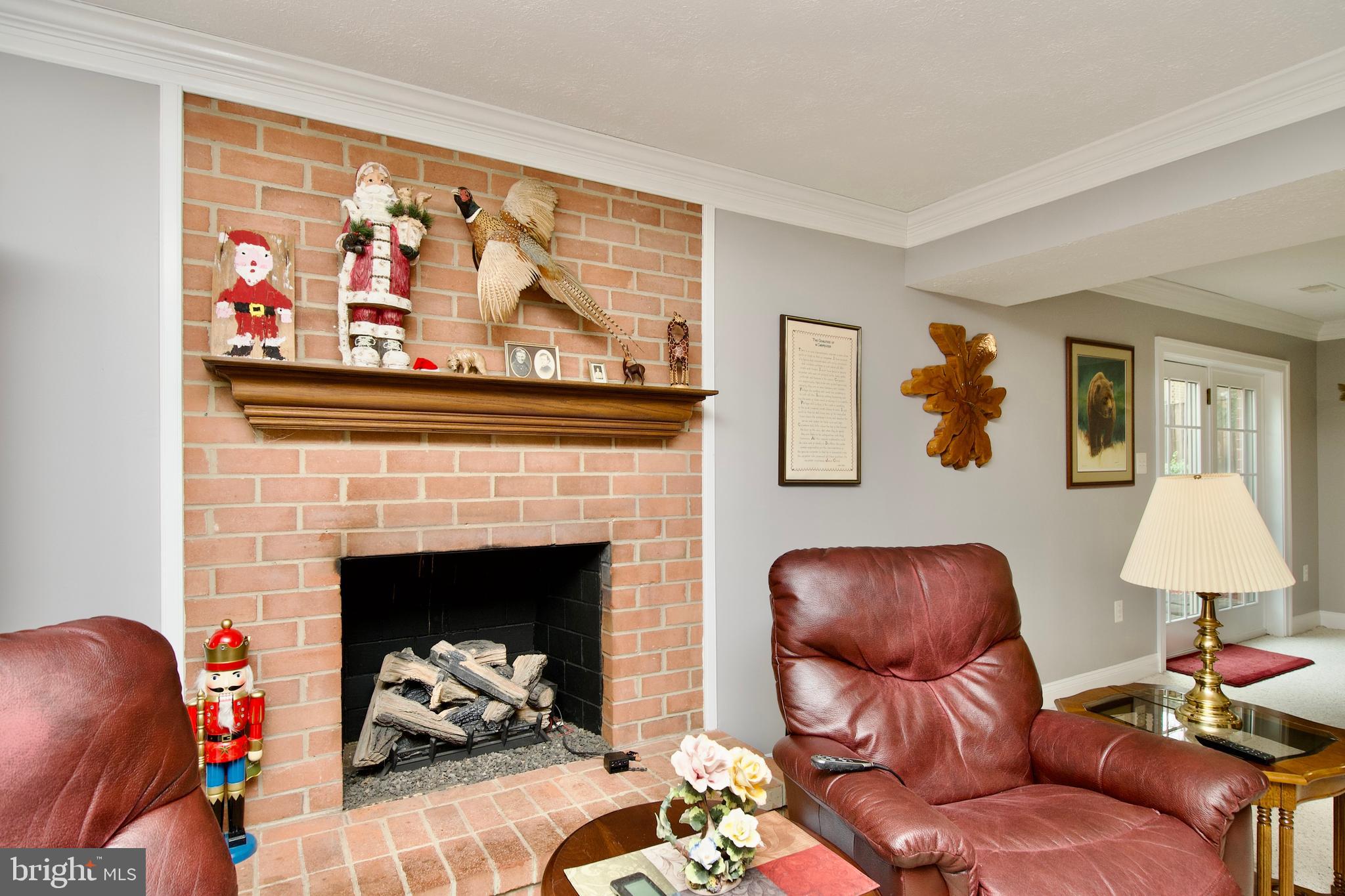 6690 Old Blacksmith Drive Burke, VA 22015 - Photo 34 of 46 a living room with furniture and a fireplace