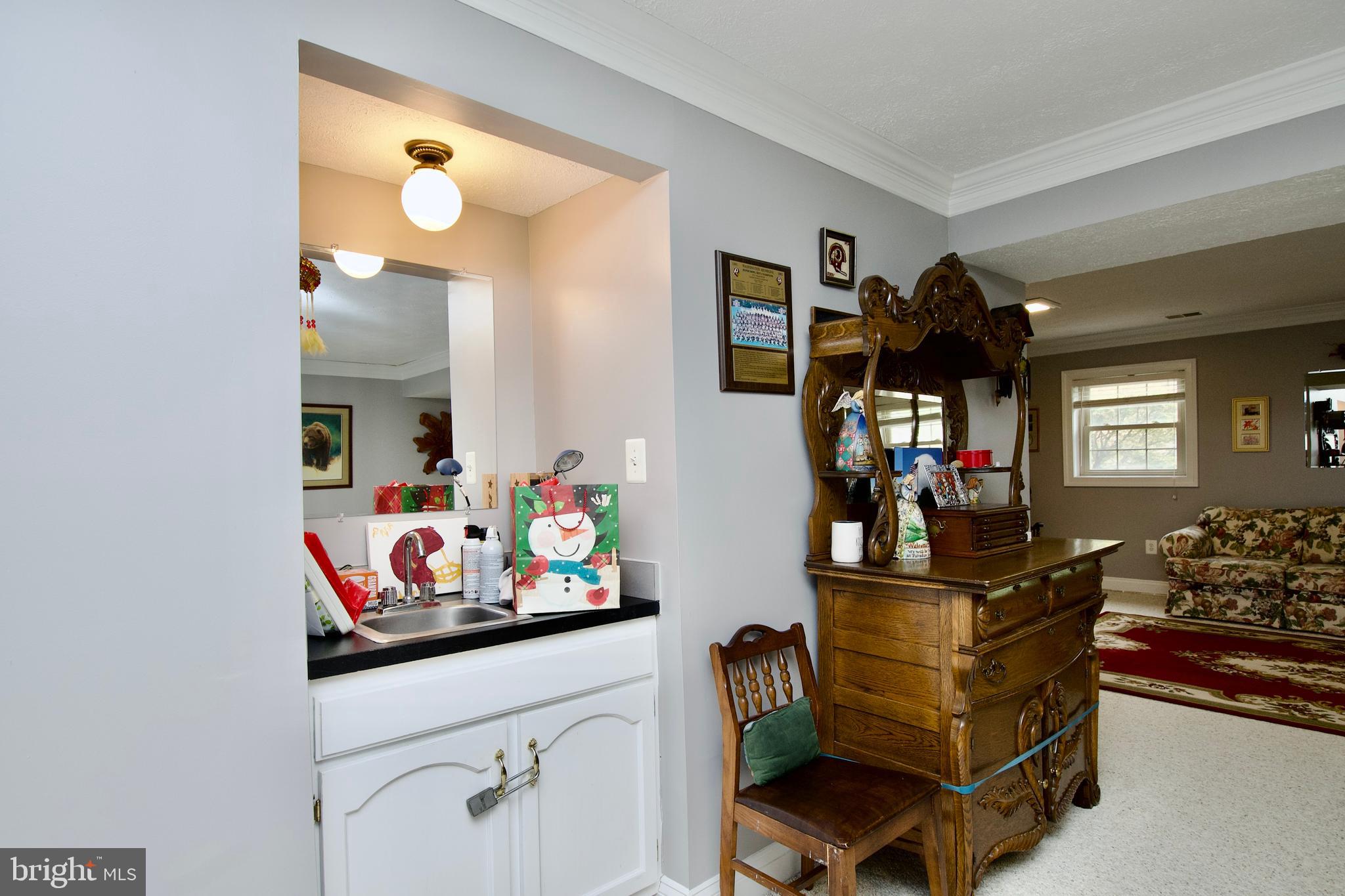 6690 Old Blacksmith Drive Burke, VA 22015 - Photo 37 of 46 a room with wooden floor and dining table
