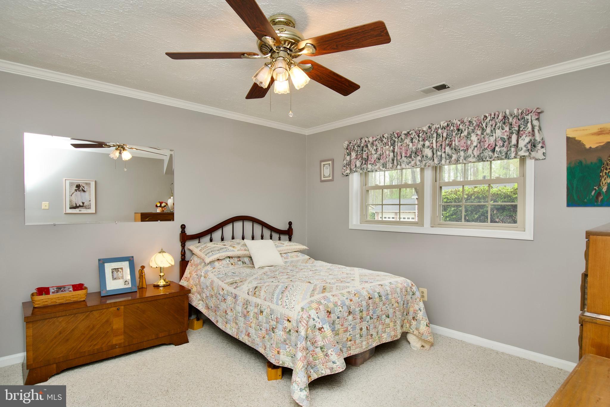 6690 Old Blacksmith Drive Burke, VA 22015 - Photo 39 of 46 a bedroom with a bed chandelier and a window
