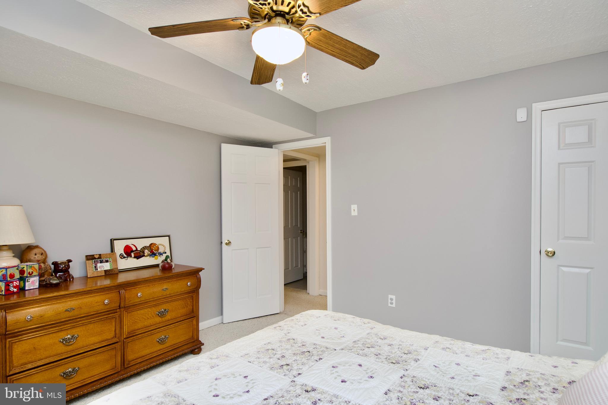 6690 Old Blacksmith Drive Burke, VA 22015 - Photo 43 of 46 a bedroom with a bed and wooden floor