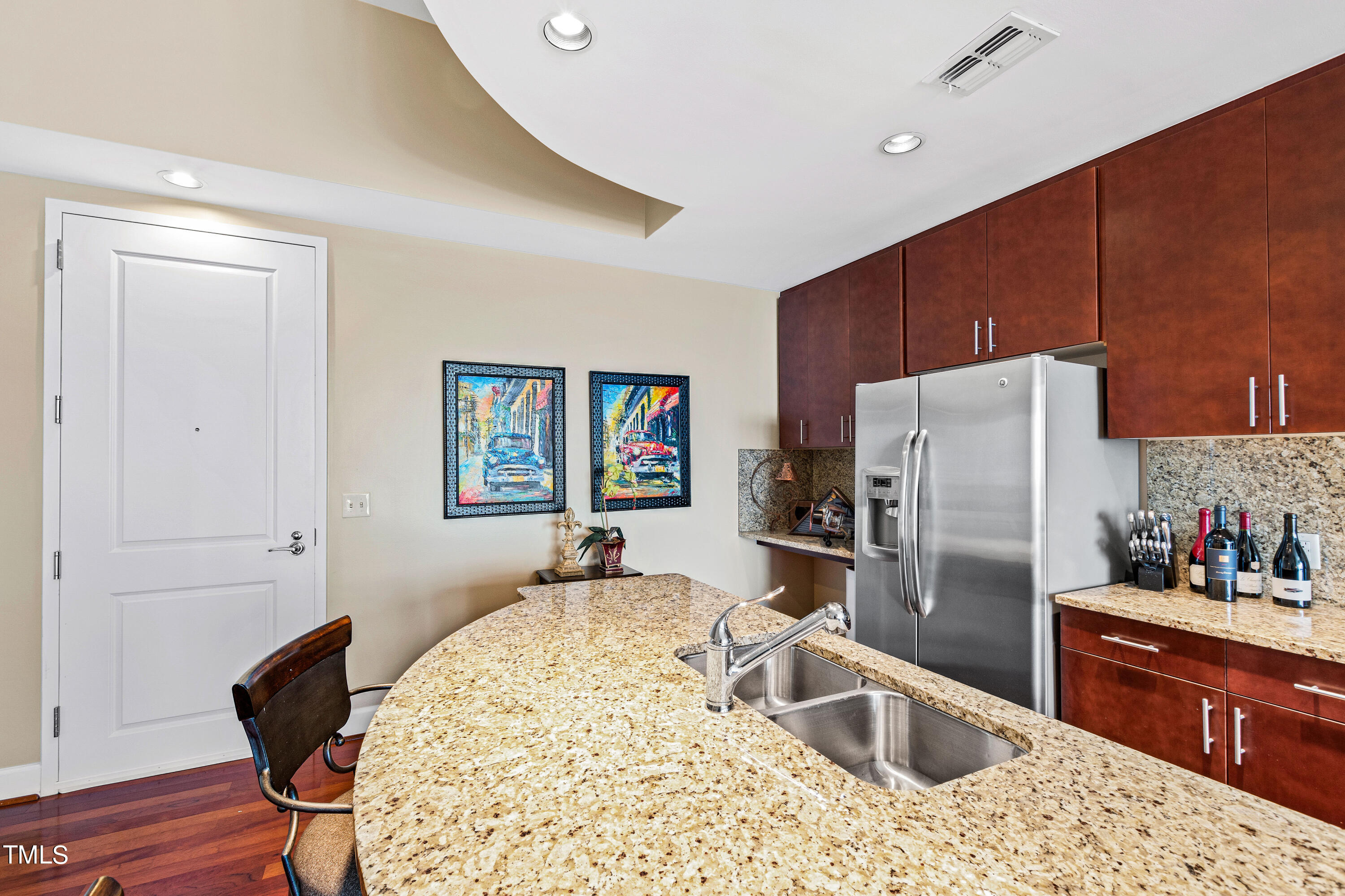 301 Fayetteville Street, Unit 3305 Raleigh, NC 27601 - Photo 11 of 80 a kitchen with stainless steel appliances kitchen island granite countertop a refrigerator and a sink