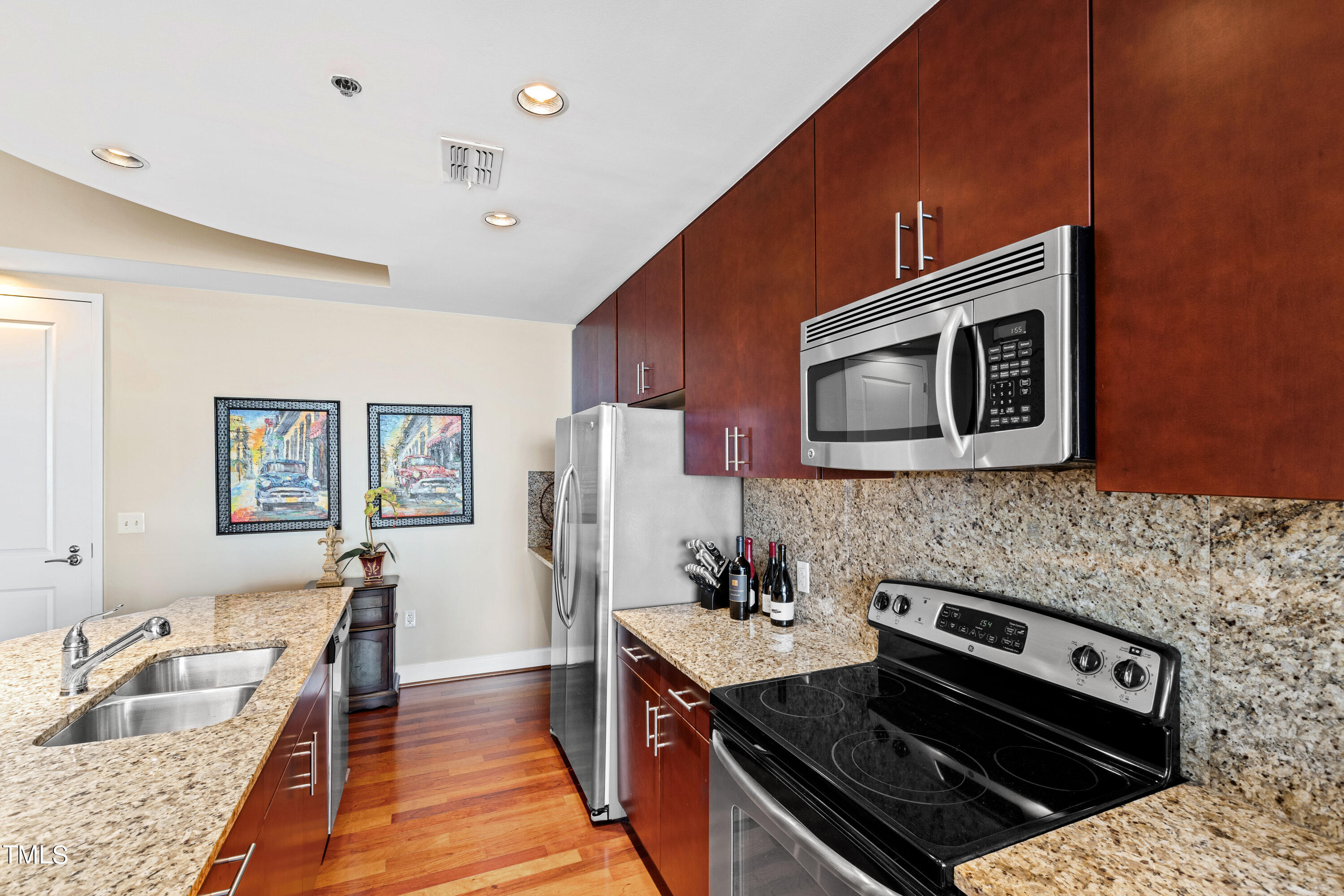 301 Fayetteville Street, Unit 3305 Raleigh, NC 27601 - Photo 13 of 80 a kitchen with stainless steel appliances granite countertop a stove a sink and a microwave