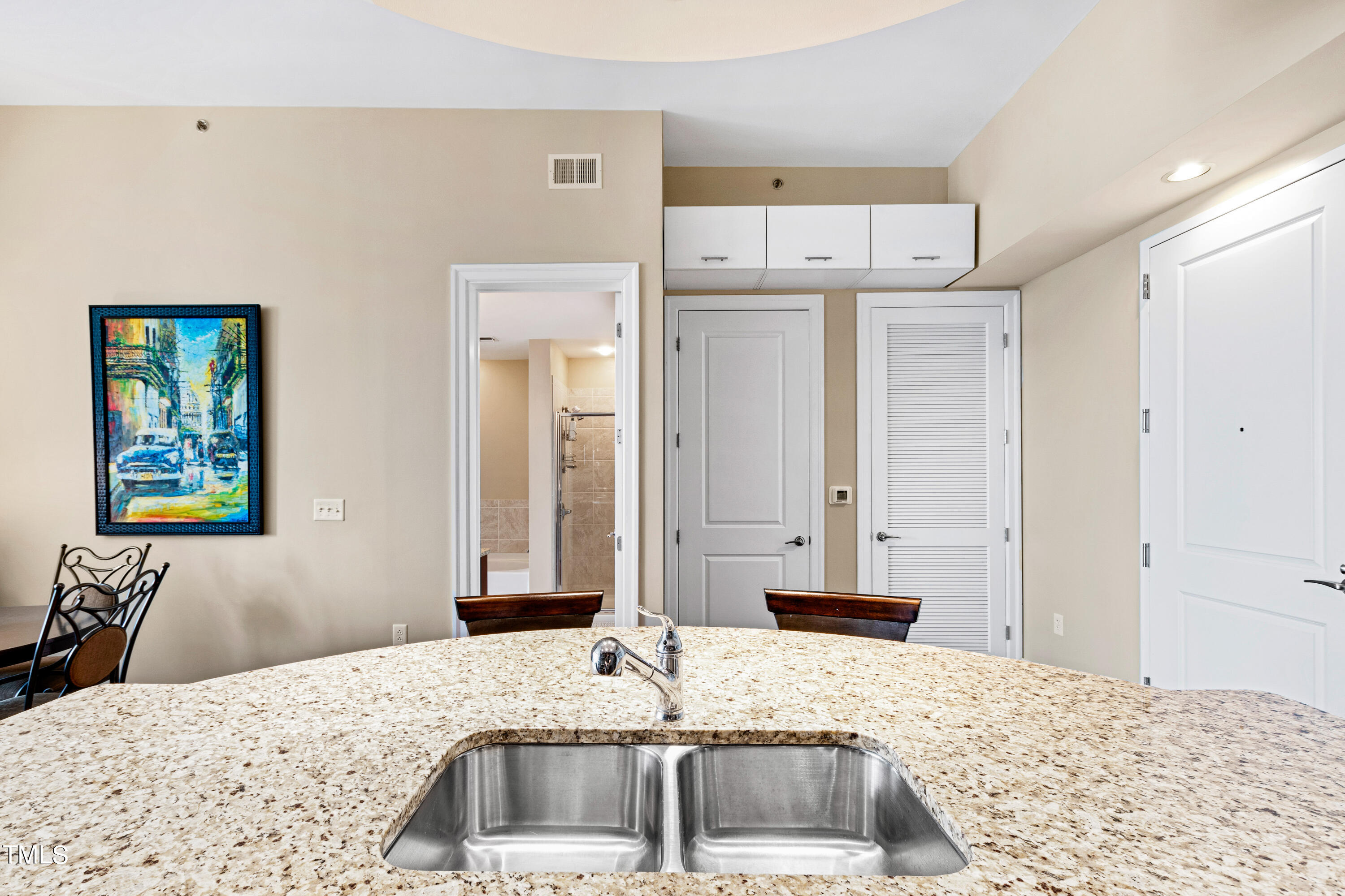301 Fayetteville Street, Unit 3305 Raleigh, NC 27601 - Photo 15 of 80 a bathroom with a granite countertop sink and a mirror