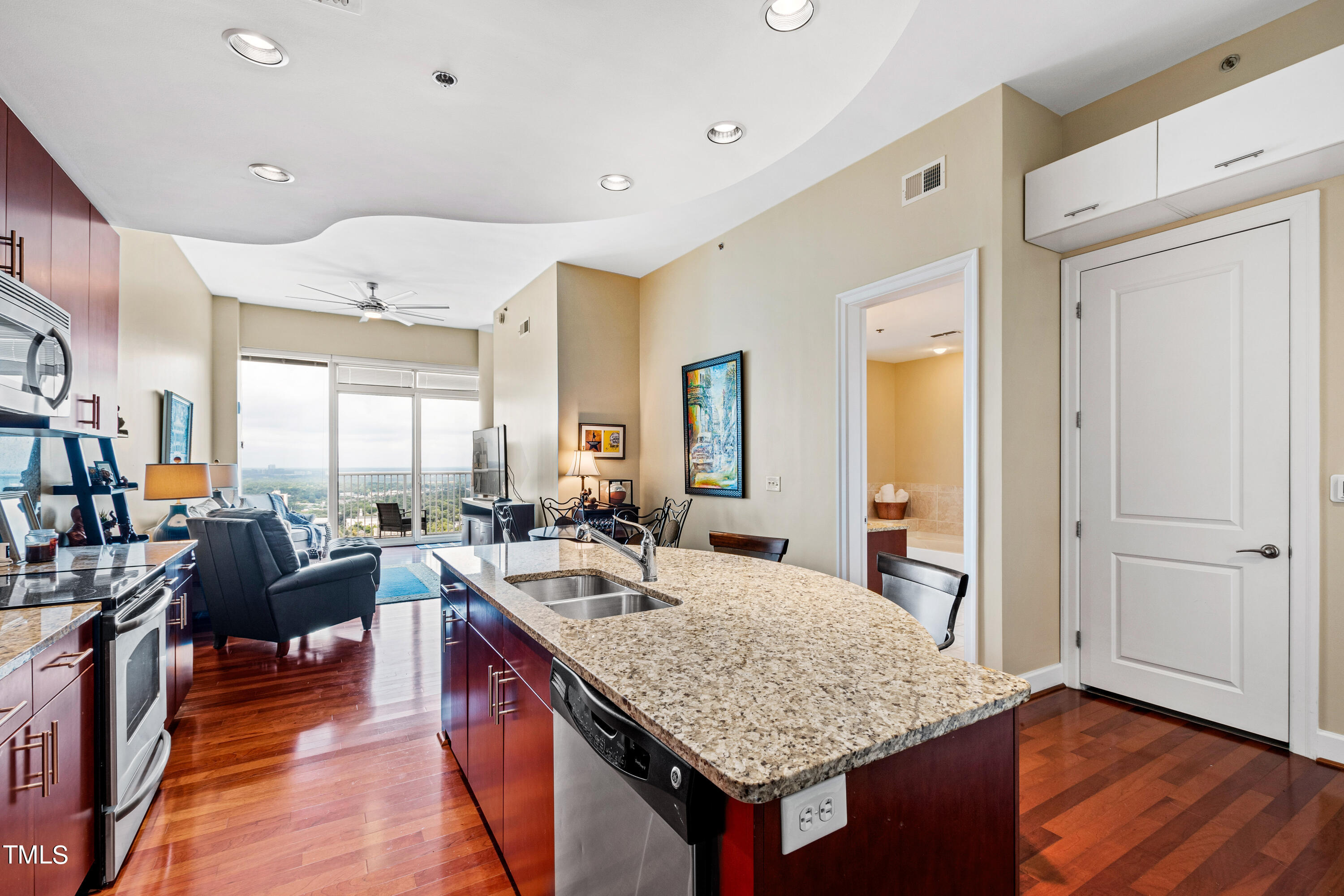 301 Fayetteville Street, Unit 3305 Raleigh, NC 27601 - Photo 18 of 80 a large kitchen with kitchen island granite countertop a large counter space and stainless steel appliances