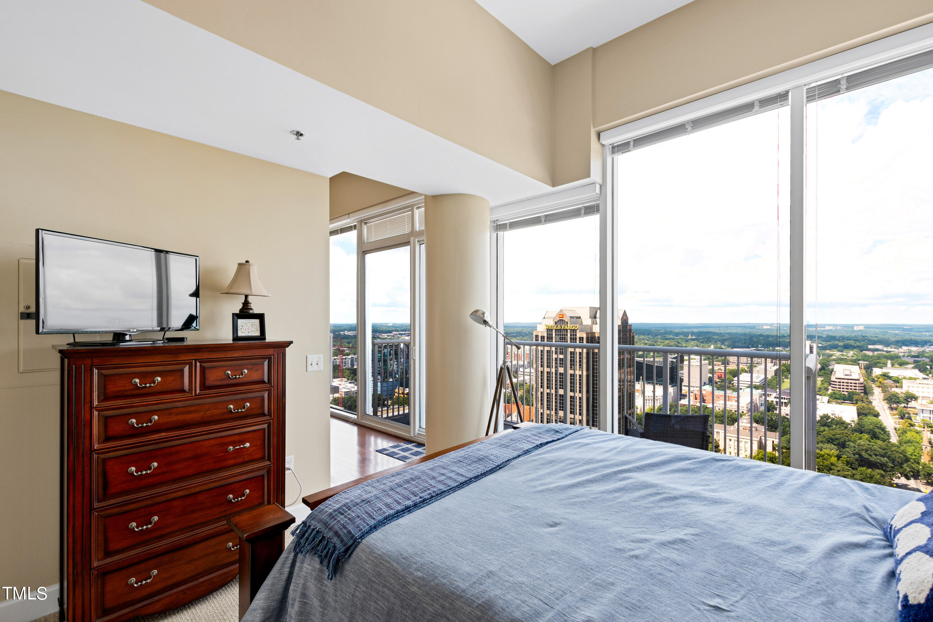 301 Fayetteville Street, Unit 3305 Raleigh, NC 27601 - Photo 29 of 80 a bedroom with a bed and large windows