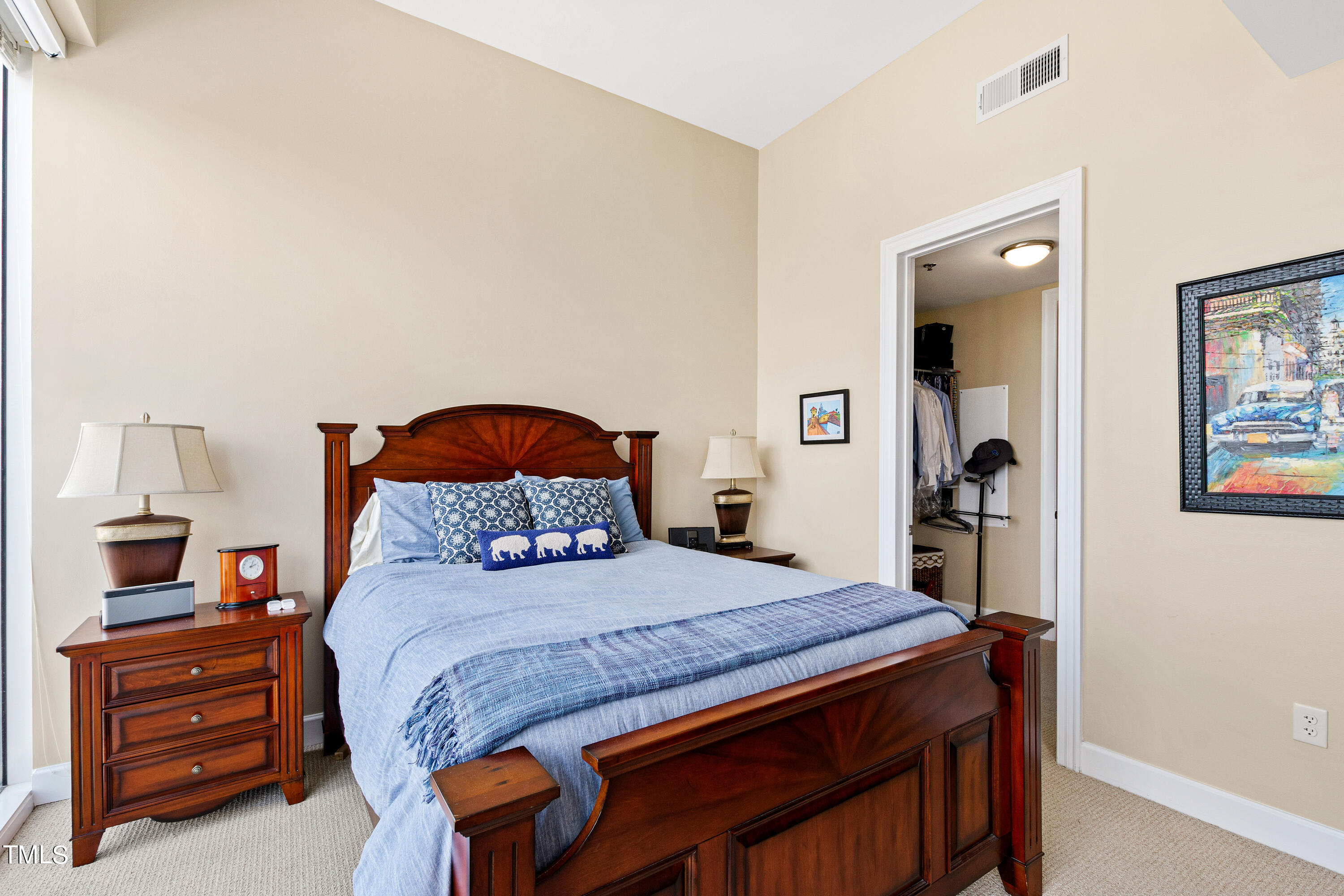301 Fayetteville Street, Unit 3305 Raleigh, NC 27601 - Photo 33 of 80 a bedroom with a bed and a dresser in it