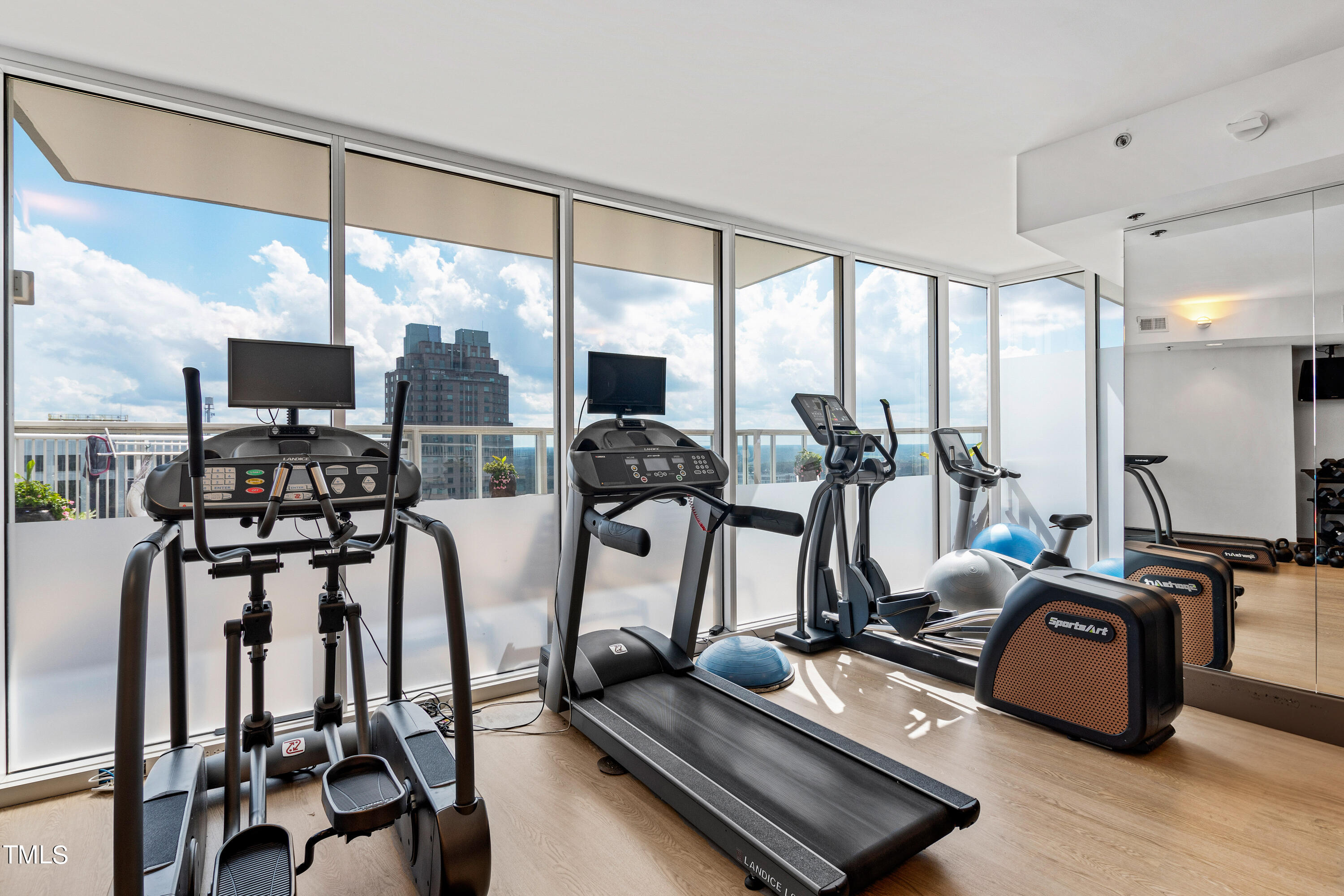 301 Fayetteville Street, Unit 3305 Raleigh, NC 27601 - Photo 52 of 80 a room with gym equipment and a large window