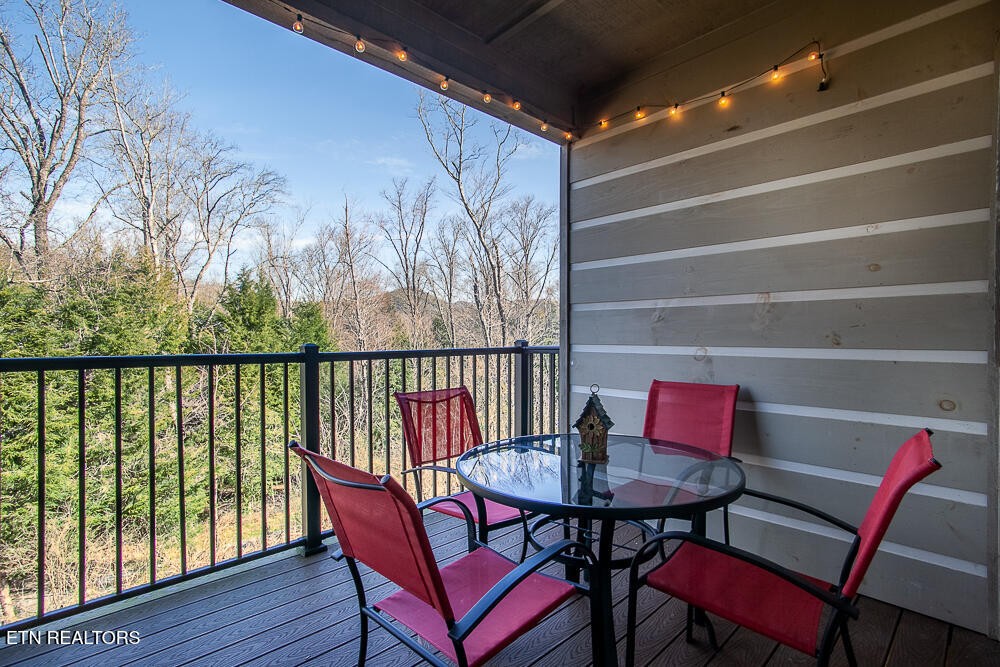 338 Shooting Star Loop, Unit 203 Townsend, TN 37882 - Photo 22 of 30 a view of a chairs and table in the balcony