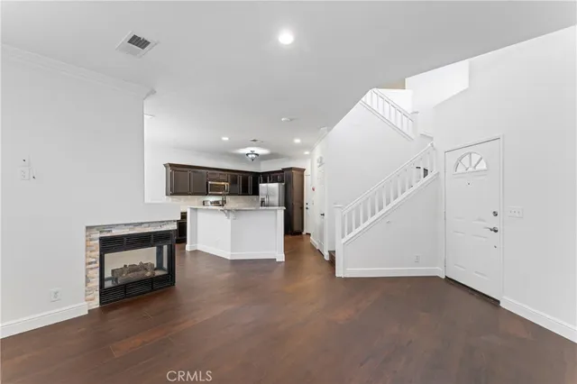 a kitchen with stainless steel appliances granite countertop a stove top oven a sink and dishwasher a oven with wooden floors