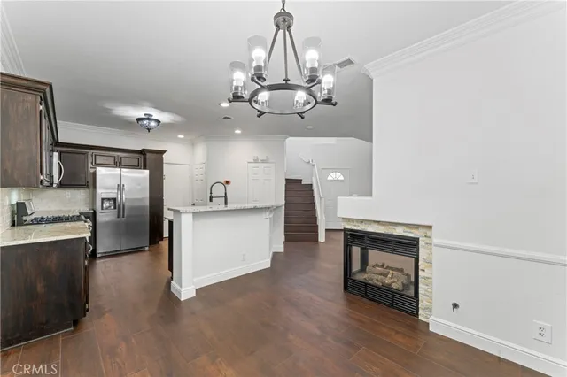 a kitchen with stainless steel appliances granite countertop a refrigerator stove and microwave