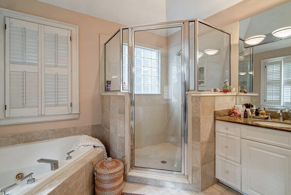 2724 Atwood Road Northeast Atlanta, GA 30305 - Photo 17 of 22 a bathroom with a bathtub shower sink mirror and toilet